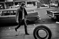 Bob Dylan rolling a tire in Greenwich Village NYC, 1963 by Jim Marshall